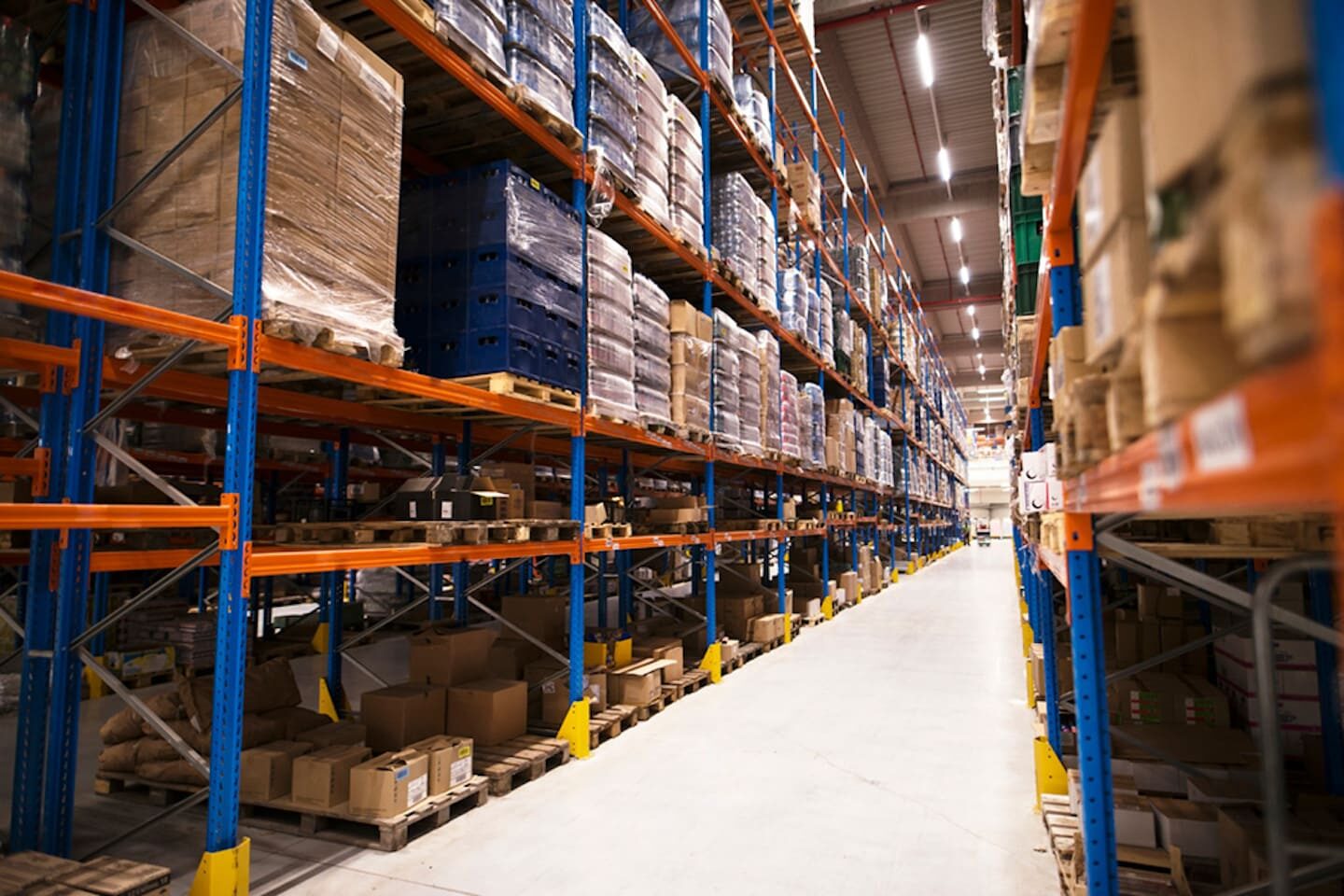 interior-large-distribution-warehouse-with-shelves-stacked-with-palettes-goods-ready-market